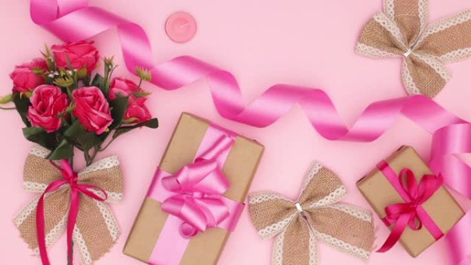 粉色浪漫花朵，粉色背景上有礼物和庆典或周年纪念配件-停止运动