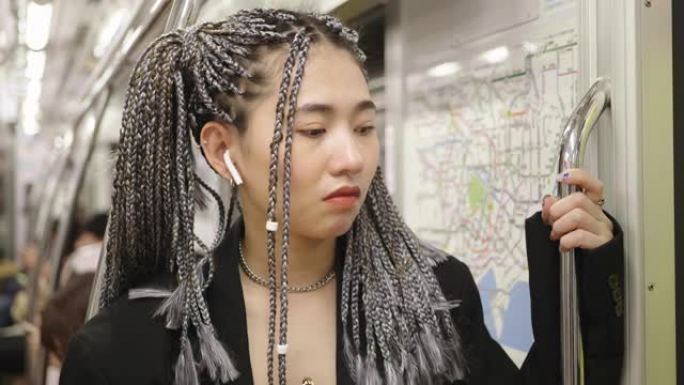 可爱的混血女孩在地铁上听音乐