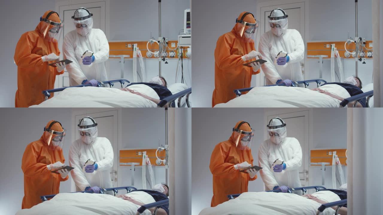 慢动作: 护士穿着防护服测量冠状病毒病人的体温，并咨询领先的医生-多莉射击。在5K R3D中拍摄