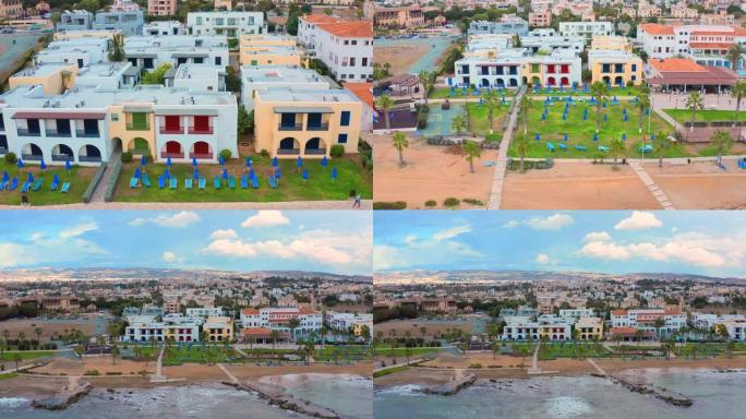 塞浦路斯帕福斯度假小镇的鸟瞰图。Amera飞回大海，露出帕福斯堤防的景色。海边有海岸的海岸线和酒店。