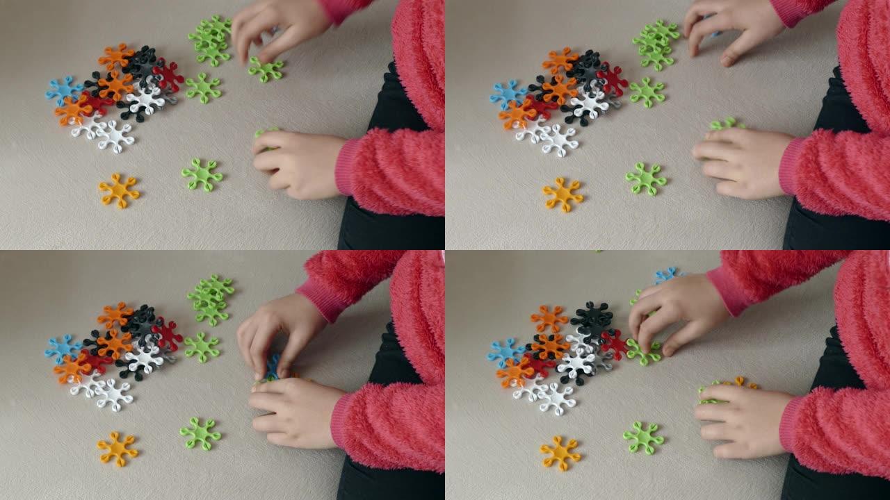 五颜六色的拼图，一个孩子正在用七巧板做定型作品，