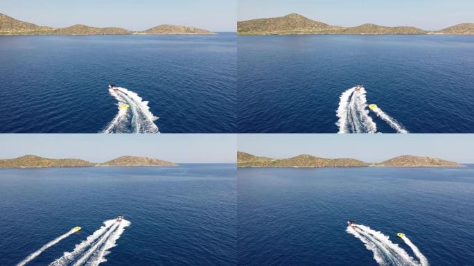 拖曳管子的摩托艇的鸟瞰图。希腊克里特岛埃隆达
