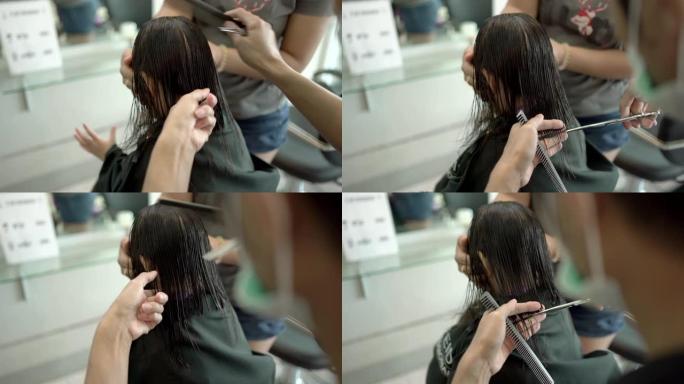 亚洲小女孩在理发店被理发师理发。手持镜头，真实直播