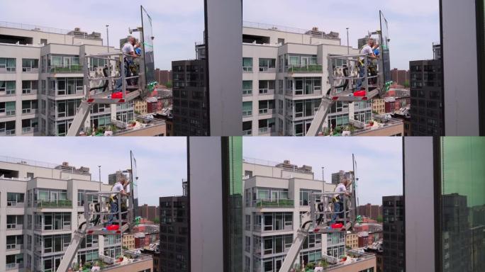 施工团队准备使用升降平台进行高空作业。纽约市哈莱姆区