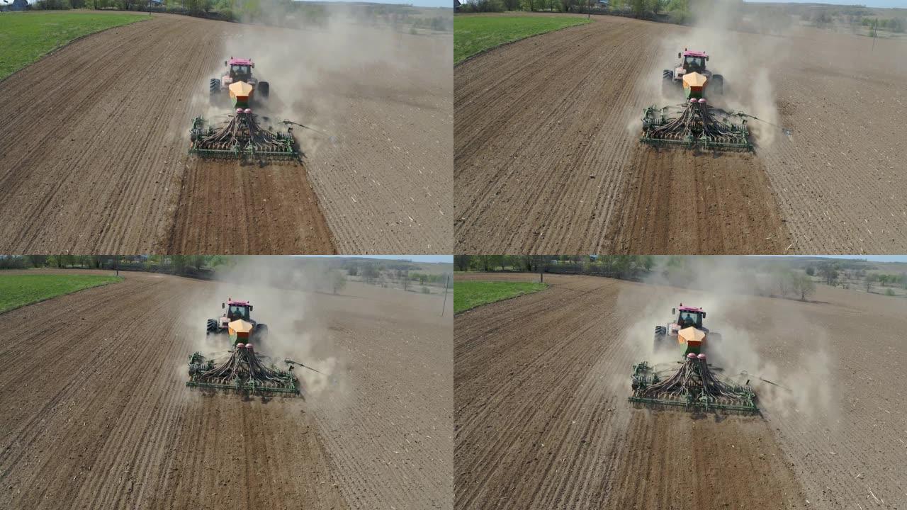 在粉尘农业田间空中用玉米种子播种的拖拉机