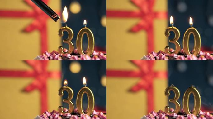 生日蛋糕30号点火器燃烧的金色蜡烛，蓝色背景礼物黄色盒子用红丝带绑起来。特写和慢动作