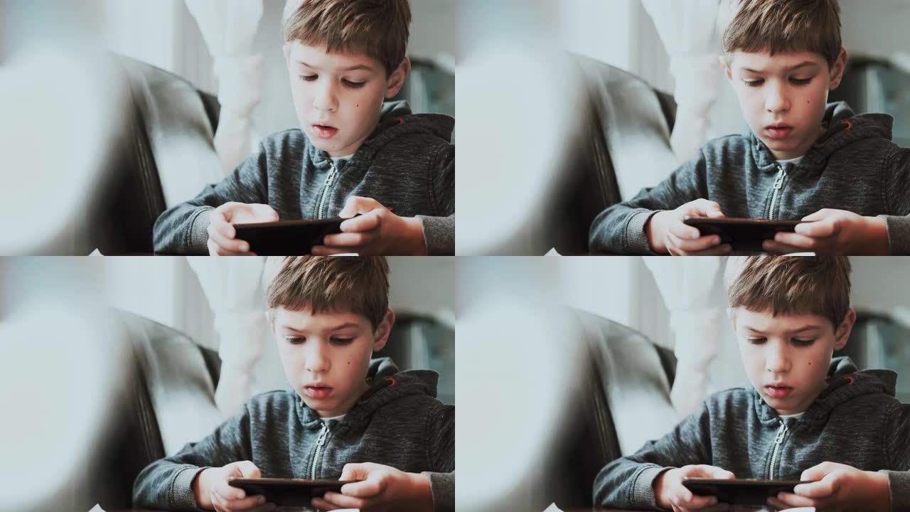 在平板电脑上玩游戏的男孩。