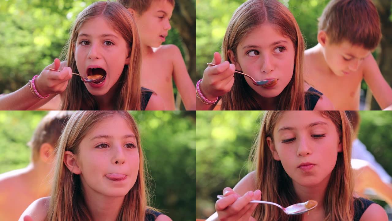 女孩的肖像与女孩吃甜点的小女孩吃甜品