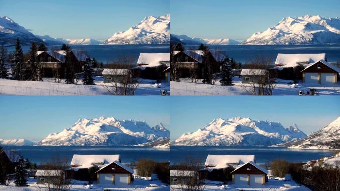 冬季挪威全景，海边的房子和远处美丽的雪山