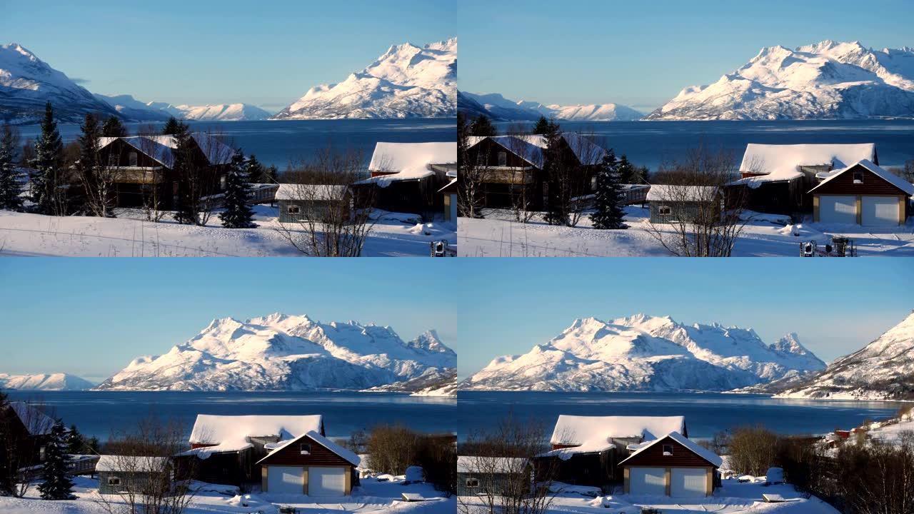 冬季挪威全景，海边的房子和远处美丽的雪山