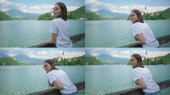 斯洛文尼亚木桥上看着湖的女孩流血