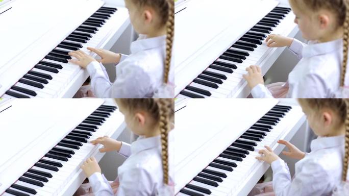 儿童在白色钢琴上演奏音乐