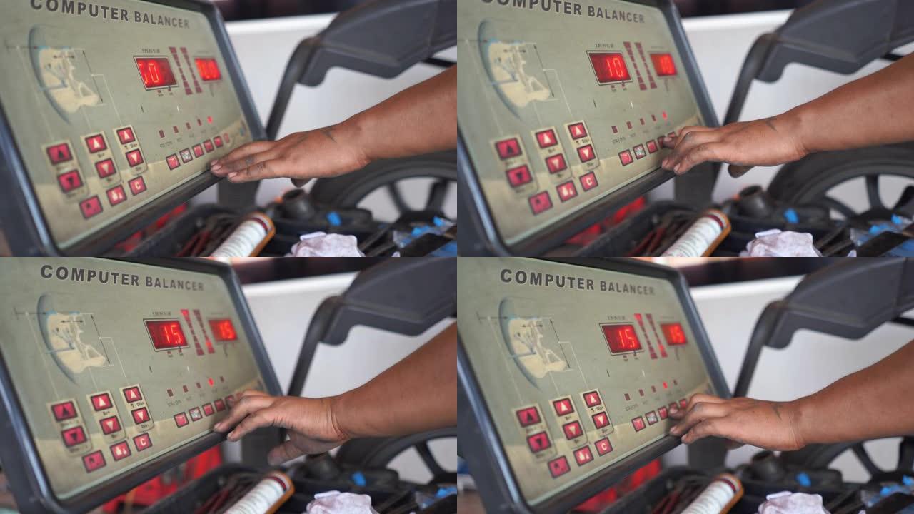 技术人员在安装前使用计算机旋转平衡汽车轮胎