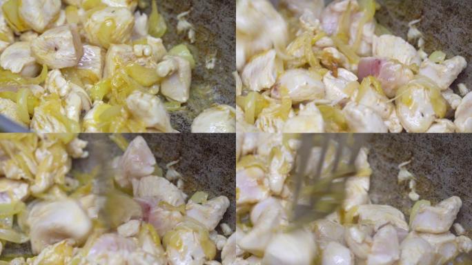 炸洋葱和鸡片在平底锅里炸。塔斯基的阿祖。烹饪。
