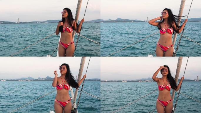 奢华游艇上穿着比基尼的美女亚洲女人