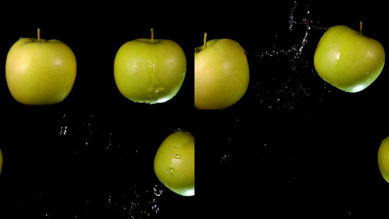 两个大青苹果在黑色背景上相互碰撞