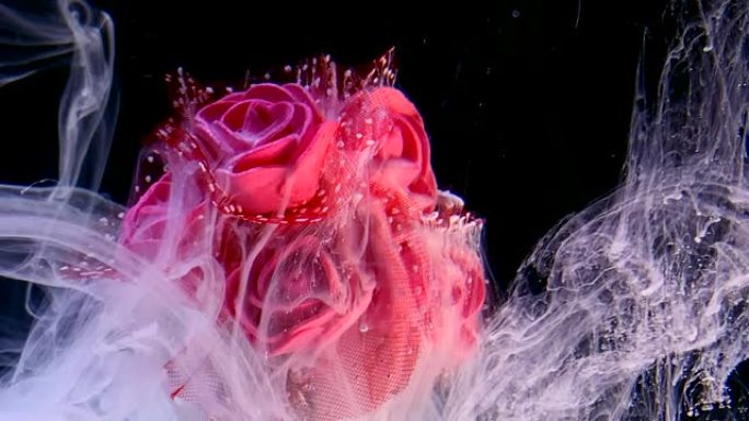 黑色背景上美丽的婚礼花束红玫瑰和白色水彩墨水在水中