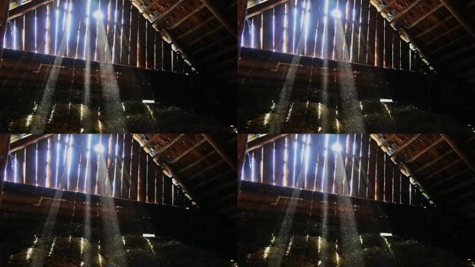 在旧谷仓的阁楼上，灰尘在太阳光线上的缓慢移动HD 1920x1080