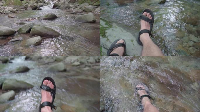 自然界中的Vlogging。一个独自旅行者在水中行走的视点。看着一条山河。