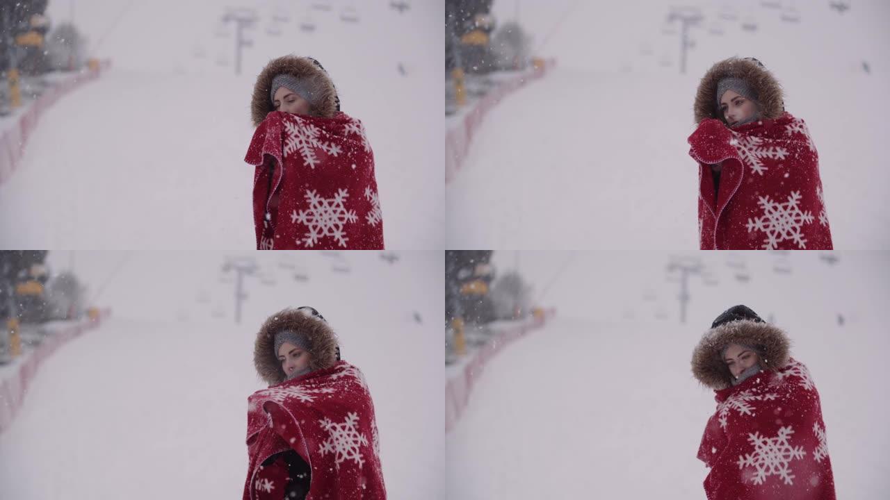 暴风雪中裹着毯子的冷冻女人的特写