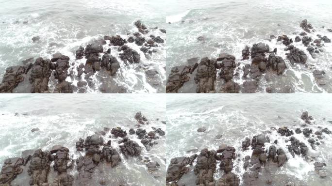 航拍广西防城港江山镇白沙湾涨潮风浪与礁石