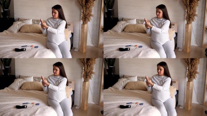 孕妇在卧室的床上用胰岛素和血糖仪。