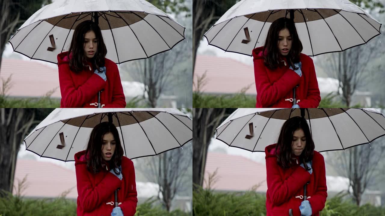 站在寒冷的雨中撑着雨伞的湿女孩