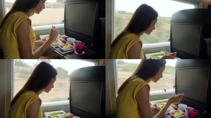 美丽的高加索女人在子弹头列车上吃美味的食物的后视图。4K