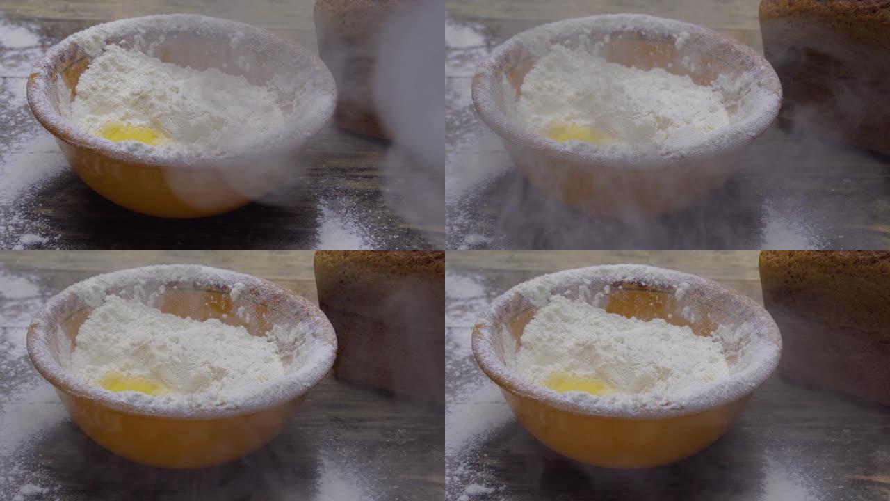 鸡蛋落入面粉，蛋黄落入面粉。烘焙产品。烹饪面团