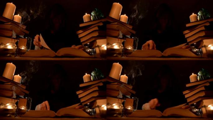 中等特写女孩魔术师在烛光下的黑暗房间里的兜帽里，寻找翻书的咒语。低调。神秘的小dop