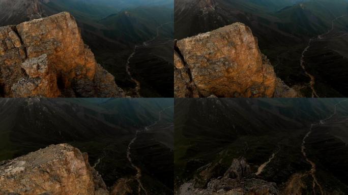 日落时无人机飞越尖锐的岩石露头的鸟瞰图。用于极端登山的陡峭的岩层山。飞行穿越旅行视频