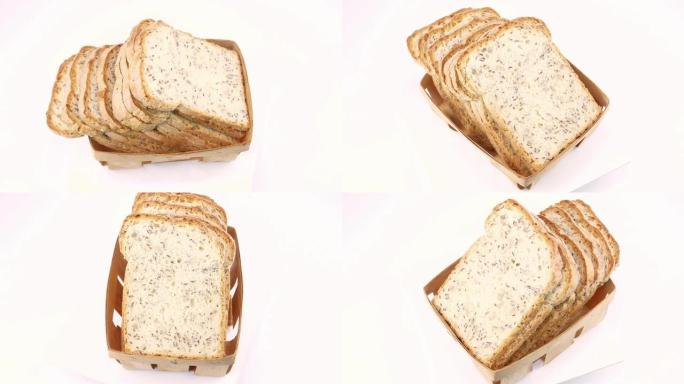 白色背景上的切片面包。亚麻籽。面包日。美食照片。文本的位置。背景图像。