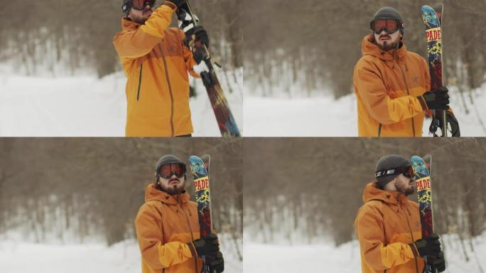 运动员滑雪板手和滑雪板一起走。男子手里拿着滑雪板，在雪地里散步，冬季运动。股票视频