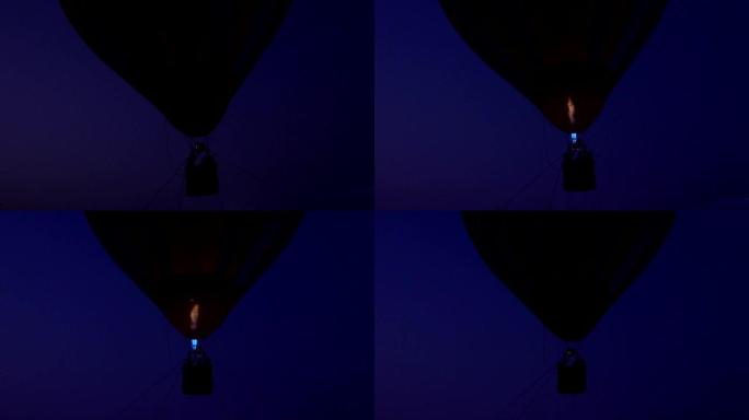 夜间在彩色热气球中飞过地面的丙烷燃气燃烧器的特写视频