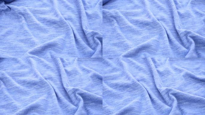 织物特写的明亮蓝色背景。蓝色斑点织物
