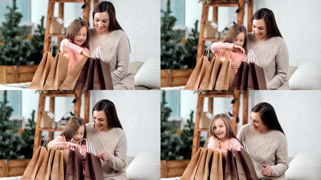 好奇的小可爱女孩打开圣诞包装袋寻找惊喜礼物享受童年