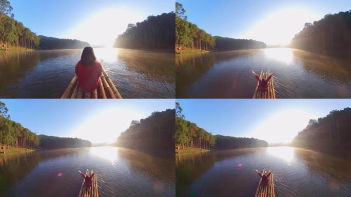 亚洲女子竹筏漂流和手臂抬高，早晨可以欣赏森林自然风光，呼吸新鲜空气。旅行概念