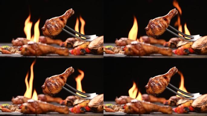 在火焰烤架上关闭烧烤烧烤鸡腿。高清慢动作。