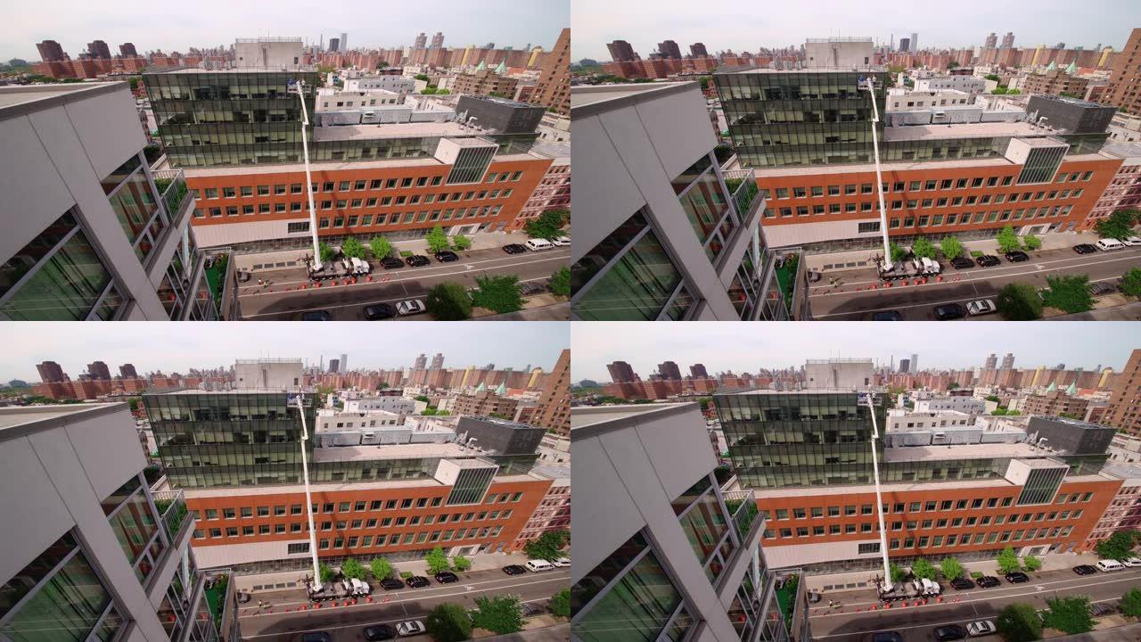 在纽约市哈林区使用升降平台进行高空作业。高角度视图。