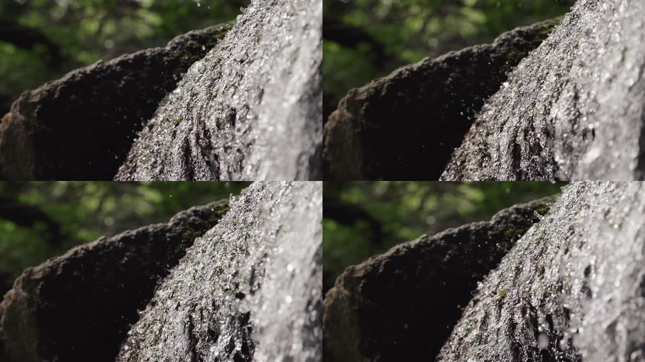 夏季特写时，瀑布纹理在绿色公园倒水