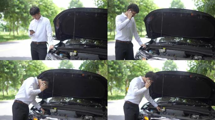 年轻人站在他的破车前，正在打电话学习汽车修理工。