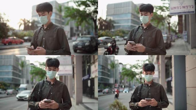 一名男子戴着口罩，在路上使用智能手机