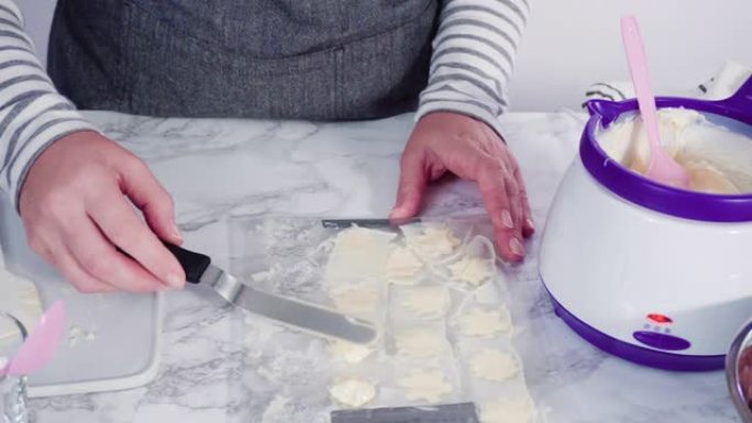 Pouring melted chocolate into a plastic chocolate 