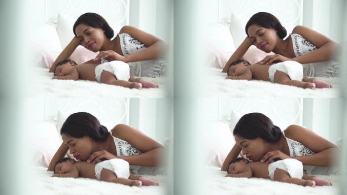 多莉视图: 美丽的非洲母亲在床上亲吻小男孩