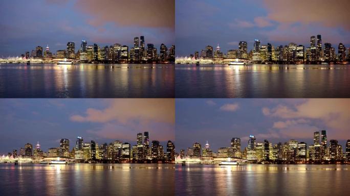从温哥华的斯坦利公园 (stanley park) 在海岸线上照亮城市的建筑物的视图