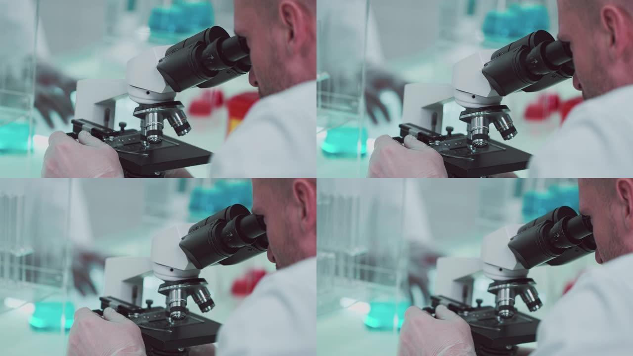 在实验室工作的人看着显微镜