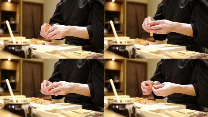 寿司厨师准备寿司，并在一家日本小餐馆omagase course为顾客服务