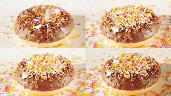 在旋转巧克力甜甜圈，甜甜圈上撒上五颜六色的糖