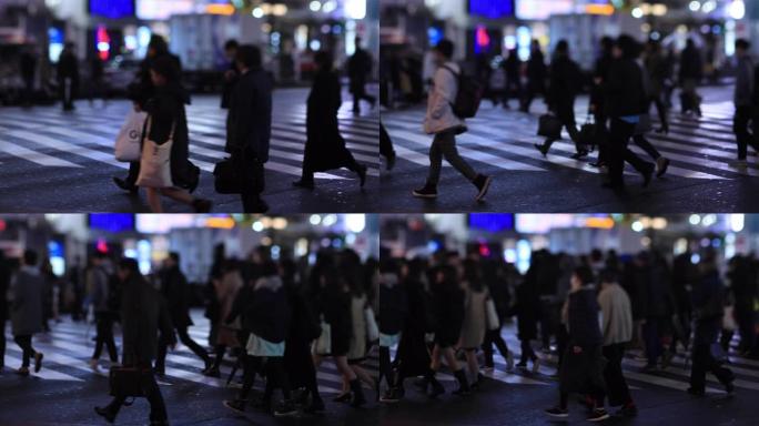 晚上在新宿东京下雨天在十字路口散步的人