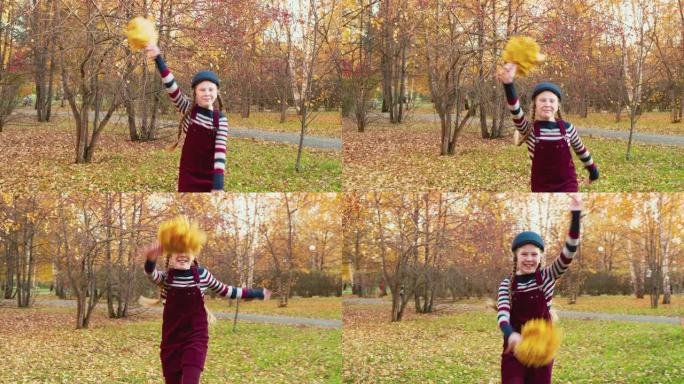 快乐的少女少年与秋天的树叶在城市公园的手。快乐的女孩有乐趣的秋天假期在城市公园。微笑的女孩在秋天的公